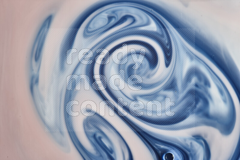 A close-up of abstract swirling patterns in blue, red and white