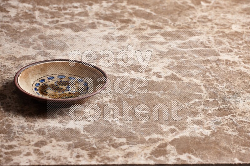 Decorative Pottery Plate on Beige Marble Flooring