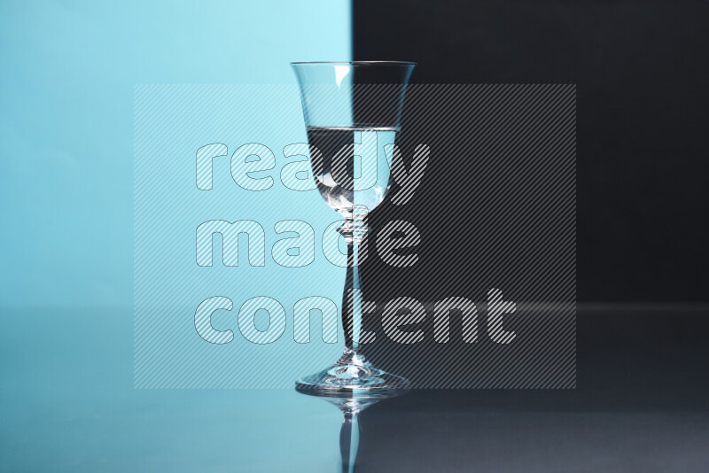 The image features a clear glassware filled with water, set against light blue and black background