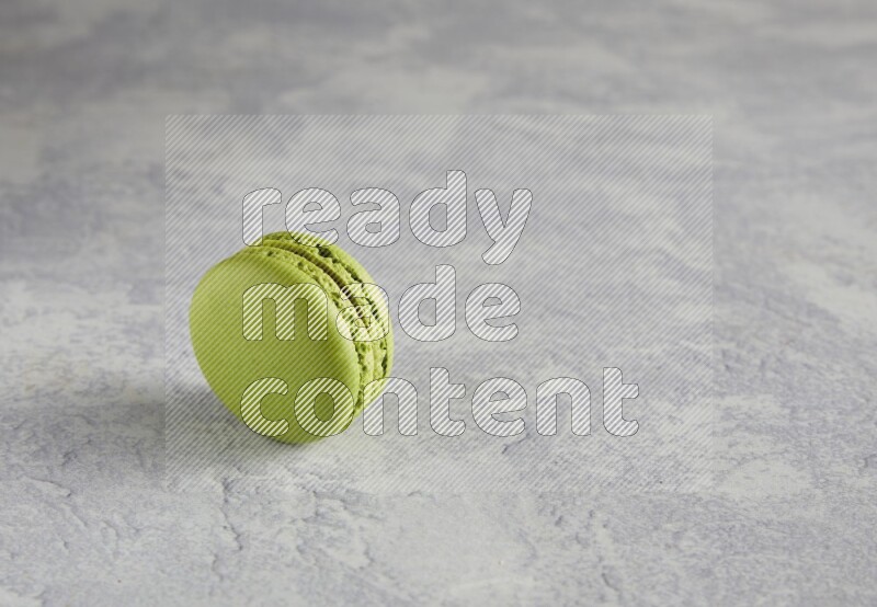45º Shot of Yellow Lime macaron on white  marble background