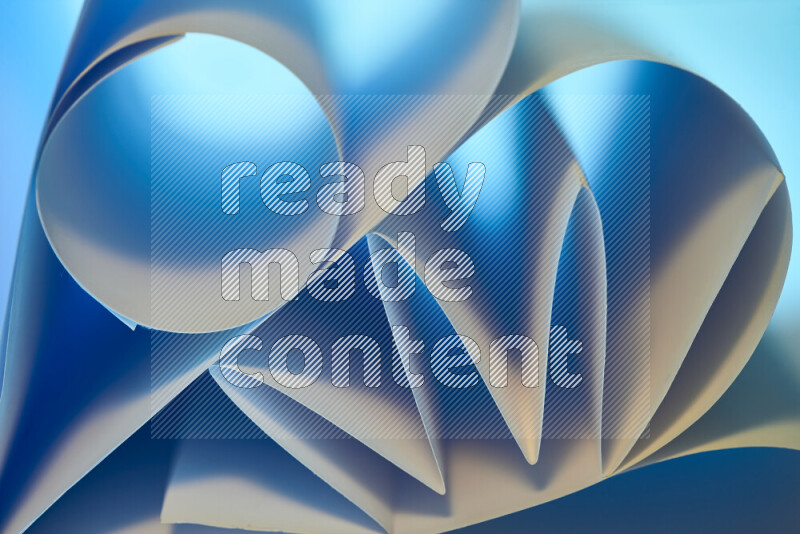 عرض فني لطيات الورق تخلق مزيج من الأشكال الهندسية، مضاءة بإضاءة ناعمة بدرجات اللون الأزرق والالوان الدافئة