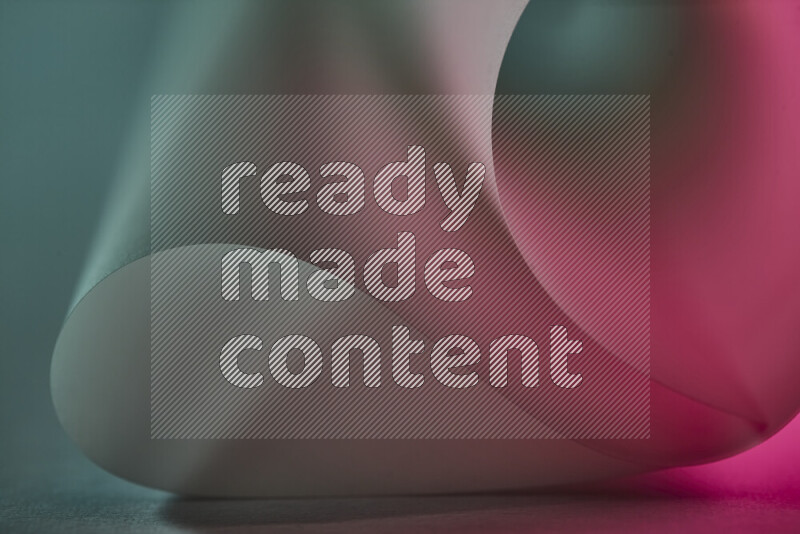 An abstract art piece displaying smooth curves in green and red gradients created by colored light