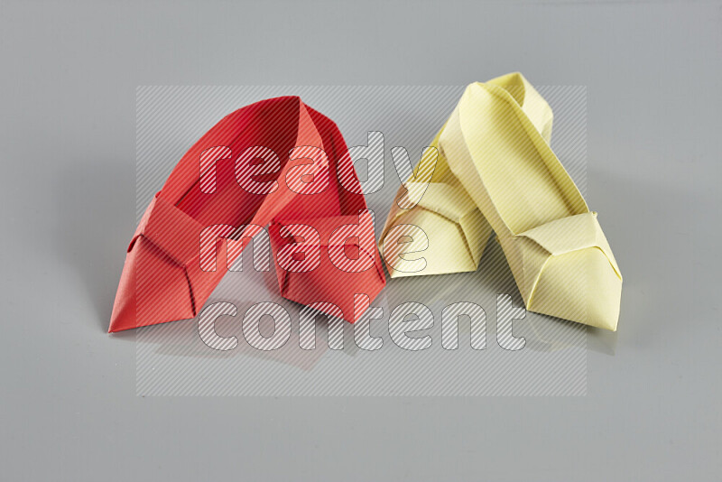 Origami shoes on grey background