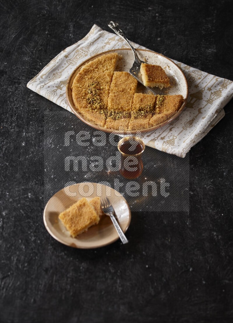 konafa with tea in a dark setup