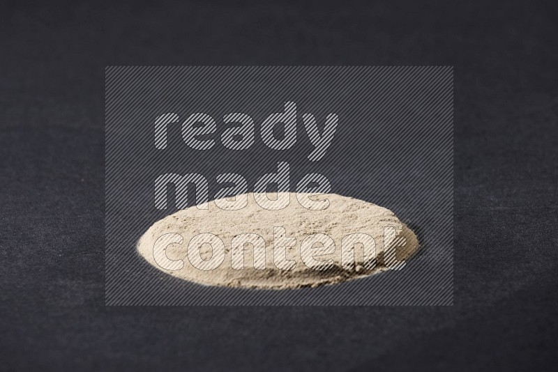 Garlic powder in a circle shape on a black flooring in different angles