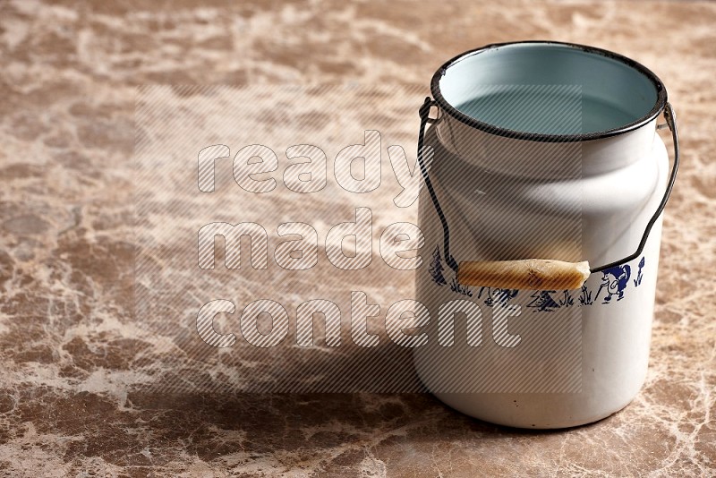 Vintage Milk Can on Beige Marble Flooring, 45 degrees