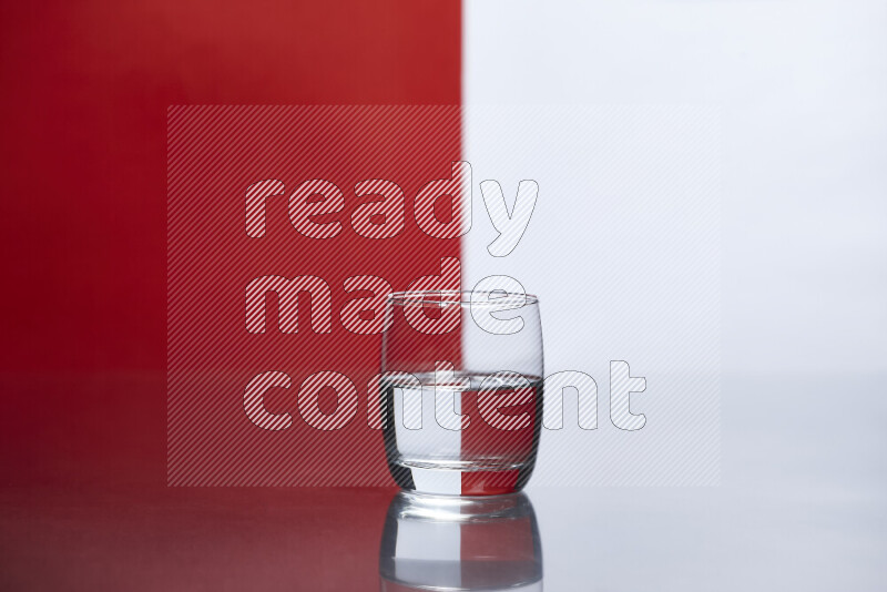 The image features a clear glassware filled with water, set against white and red background