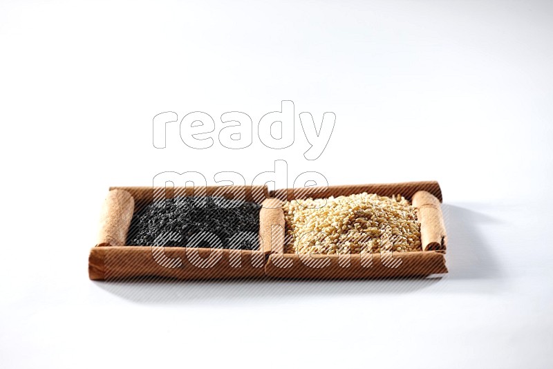 2 squares of cinnamon sticks full of sesame and black seeds on white flooring