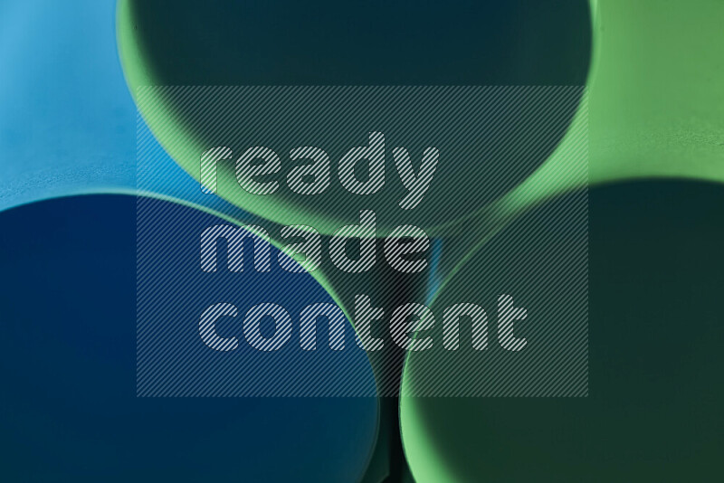 The image shows an abstract paper art with circular shapes in varying shades of green and blue