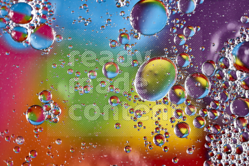 Close-ups of abstract soap bubbles and water droplets on multicolored background