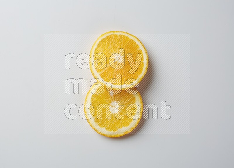 Two orange slices on white background