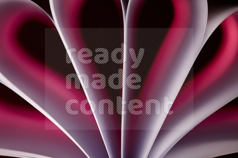 An abstract art piece displaying smooth curves in pink gradients created by colored light