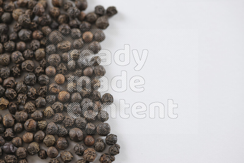 Black pepper beads on white background