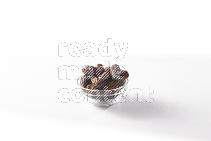 Dates in a glass bowl on white background