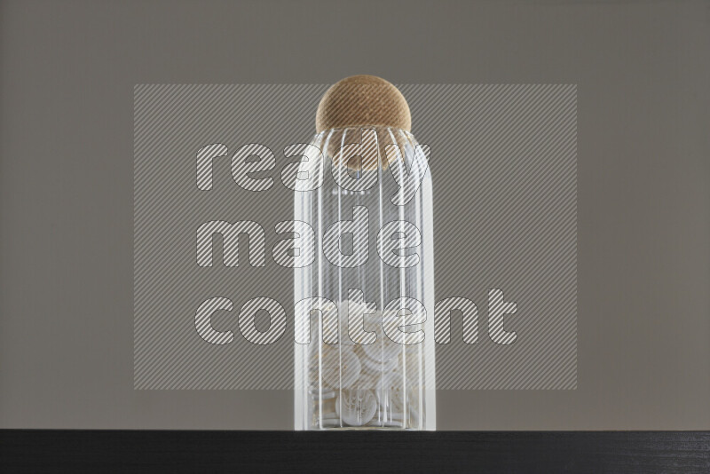 Buttons in a glass jar on black background