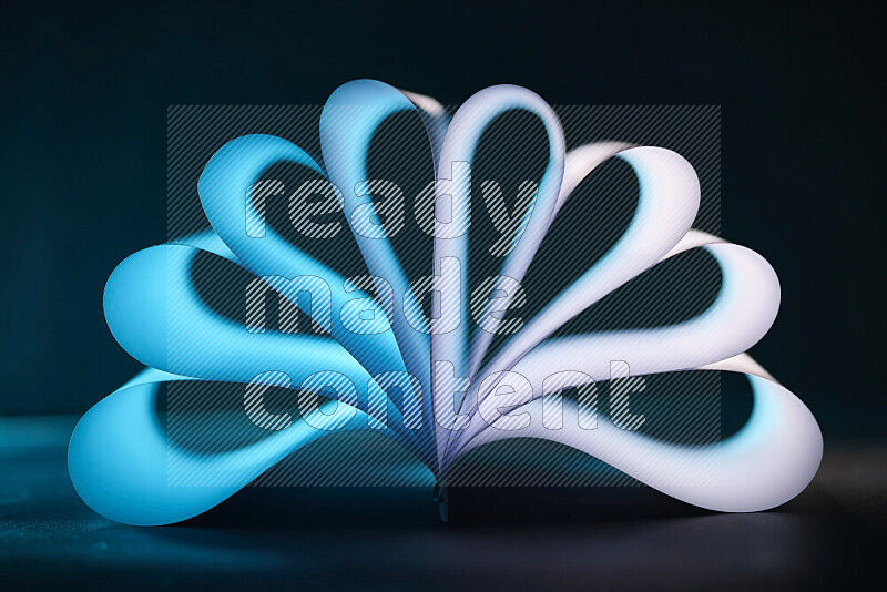 An abstract art piece displaying smooth curves in blue and white gradients created by colored light