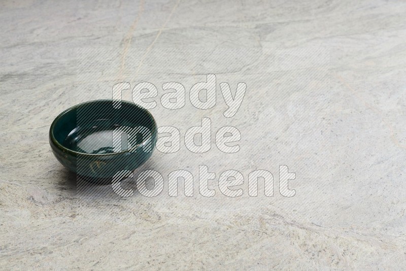 Dark Green Pottery Bowl On Grey Marble Flooring