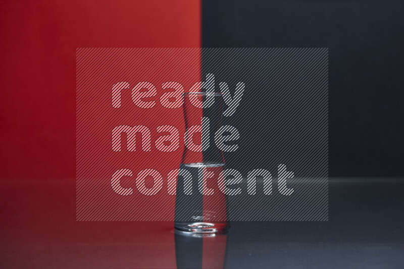 The image features a clear glassware filled with water, set against red and black background