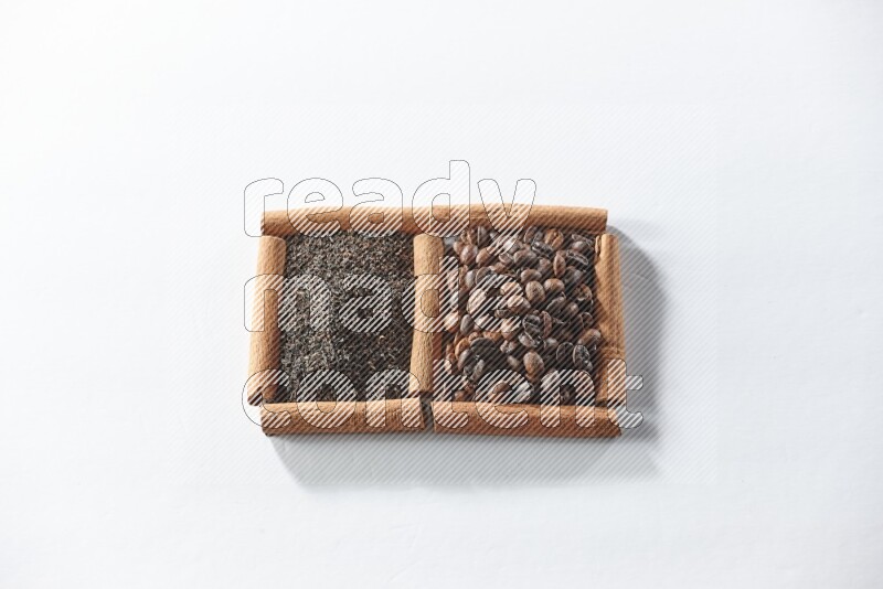 2 squares of cinnamon sticks full of coffee beans and black tea on white flooring