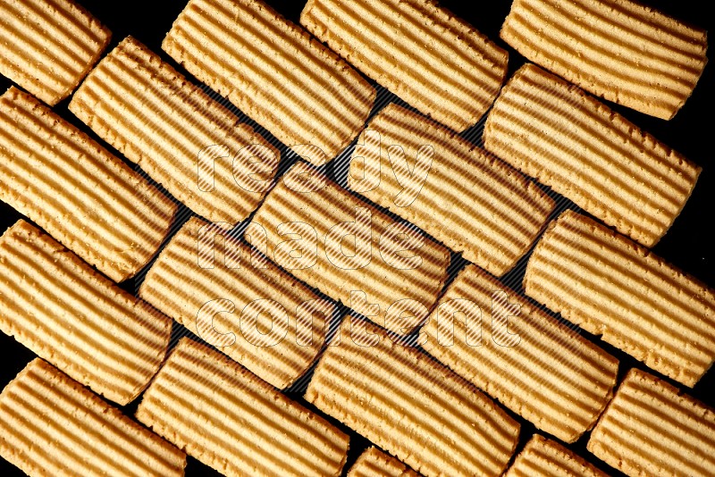 Top View of Plain Tea Biscuits Cookies filling the frame on Black Flooring