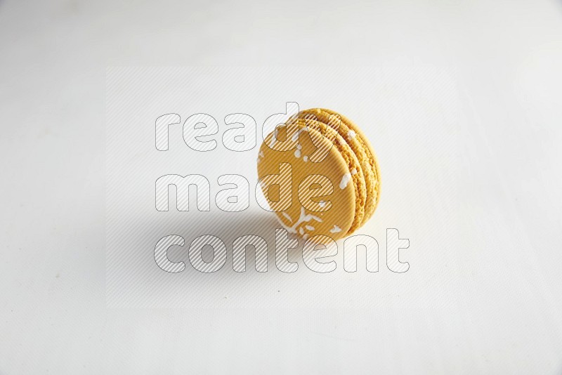 45º Shot of Yellow Piña Colada macaron on white background