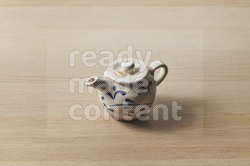 Pottery Teapot on Oak Wooden Flooring, 45 degrees