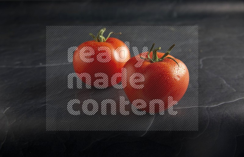 45 degree roma tomato on a textured black slate background