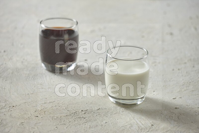Cold drinks in a glass cup such as water, tamarind, qamar eldin, sobia, milk and hibiscus on textured white background