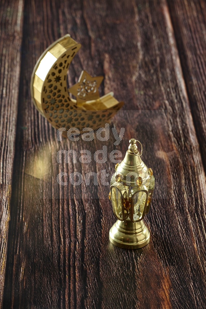 A crescent lantern with classic lantern on brown wooden background