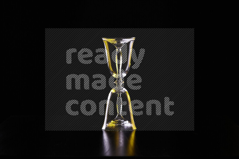 Glassware with rim light in yellow and white against black background