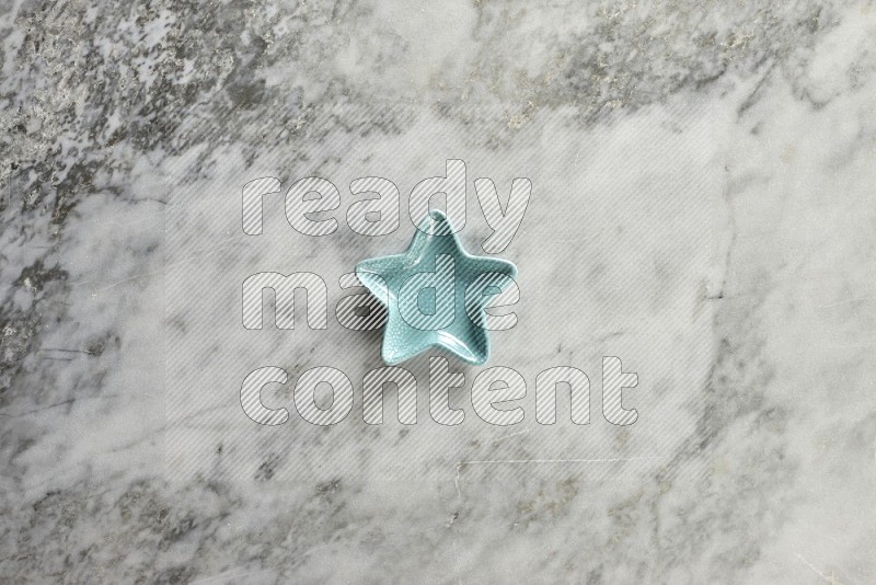 A pottery star plate on grey marble background