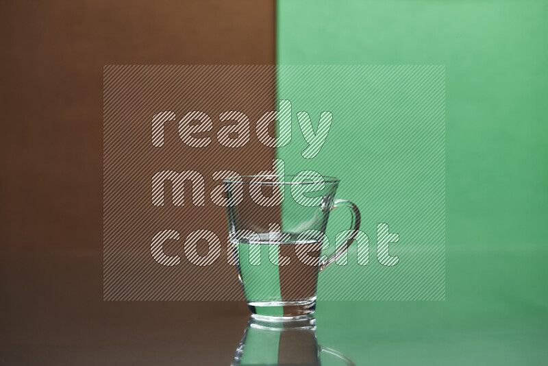 The image features a clear glassware filled with water, set against brown and green background