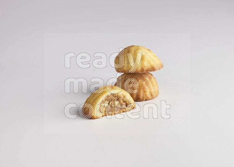 Three Pieces of Maamoul filled with walnut paste  one of them is cut direct on white background