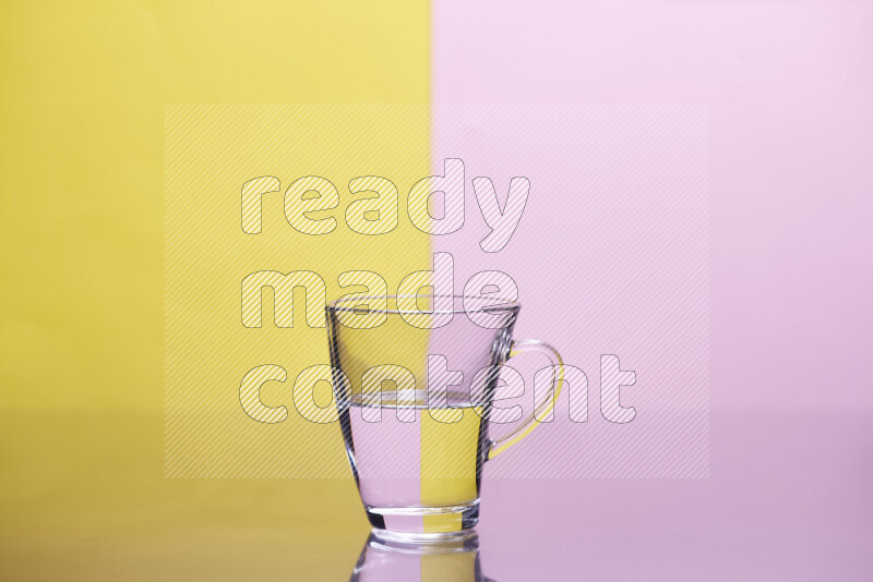 The image features a clear glassware filled with water, set against yellow and rose background