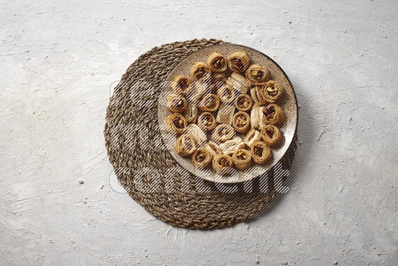 Oriental sweets in pottery plates in a light setup