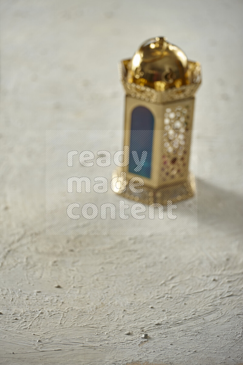 A lantern placed on a textured white background