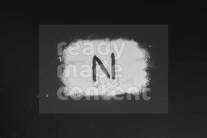 Alphabets written with powder on black background