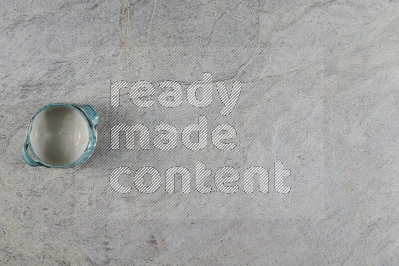 A multicolored pottery Bowl on grey marble background