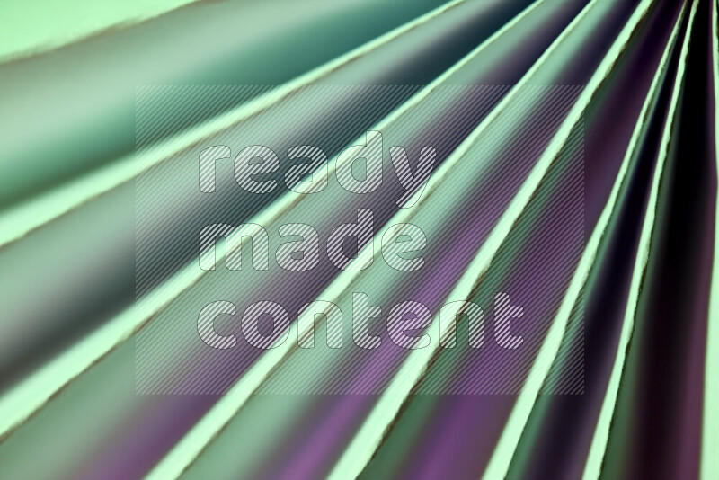 An image presenting an abstract paper pattern of lines in green and pink tones
