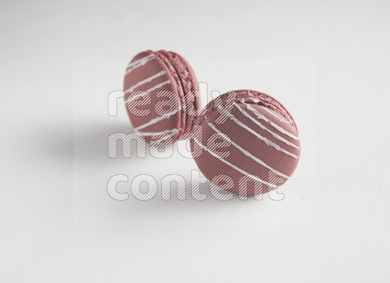 45º Shot of two Red Poppy Flower macarons on white background