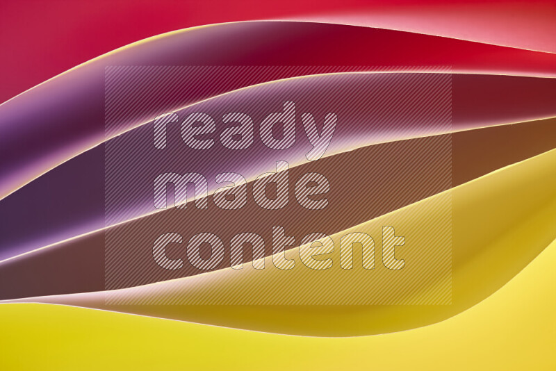 This image showcases an abstract paper art composition with paper curves in yellow, red and brown gradients created by colored light