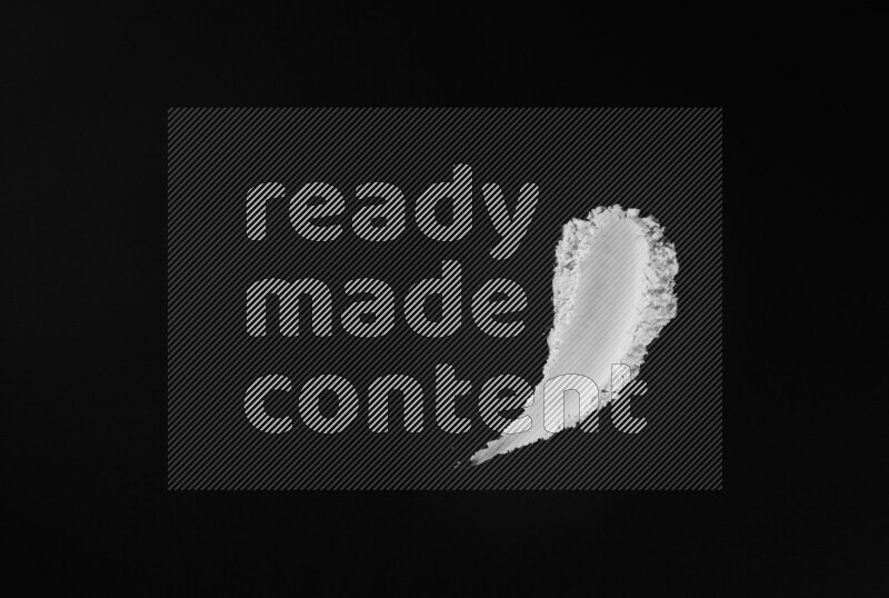 White powder strokes on black background
