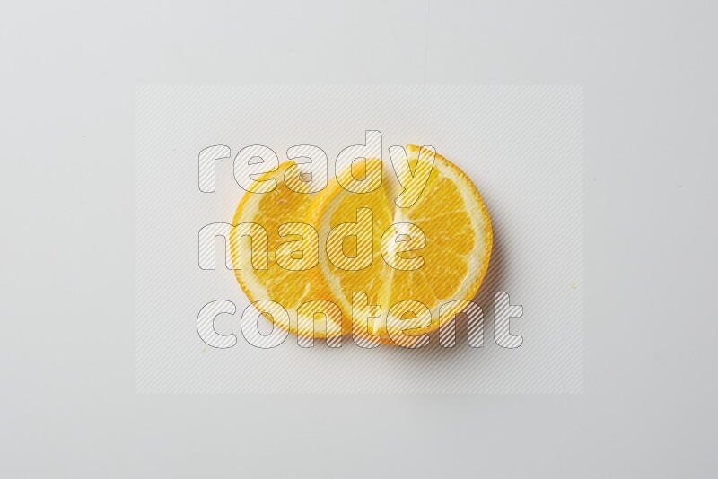 Three halves of an orange slices on white background
