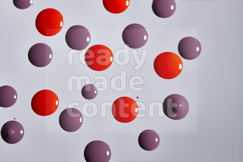 Close-ups of abstract purple and red paint droplets on the surface