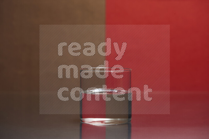 The image features a clear glassware filled with water, set against brown and red background