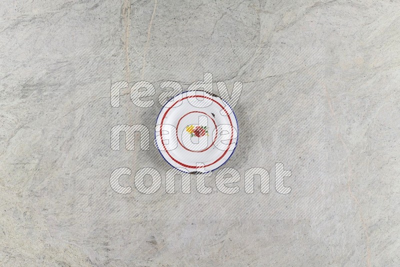 Top View Shot Of A Vintage Metal Plate On Grey Marble Flooring