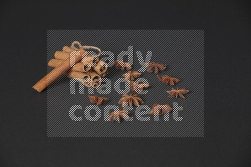 أعواد القرفة المربوطة مع اليانسون النجمي علي خلفية سوداء