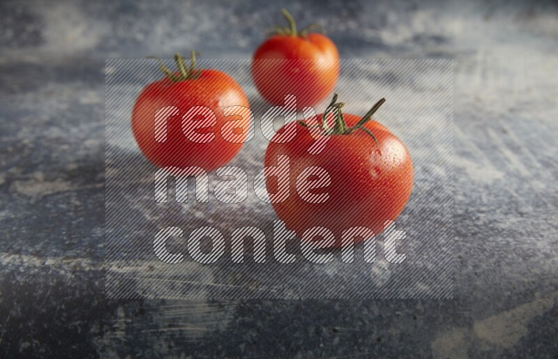45 degree roma tomato on a textured rustic blue background