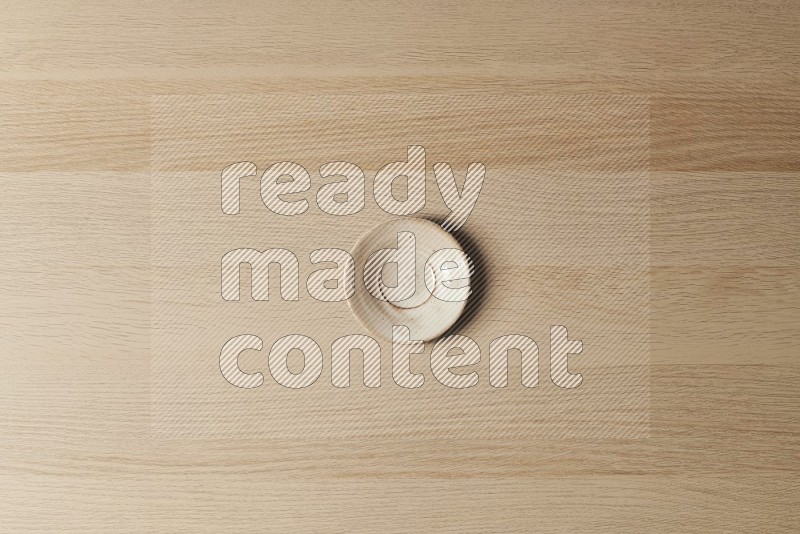 Top View Shot Of A Pottery Coaster on Oak Wooden Flooring