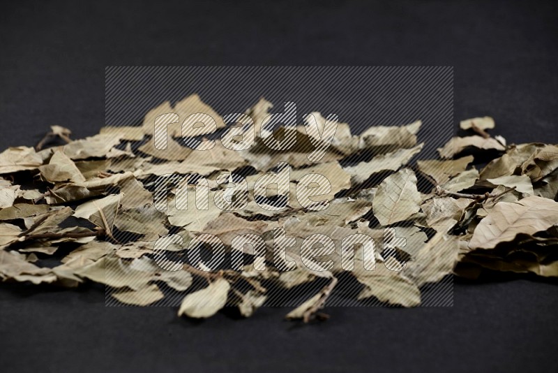 Dried bay leaves on black flooring
